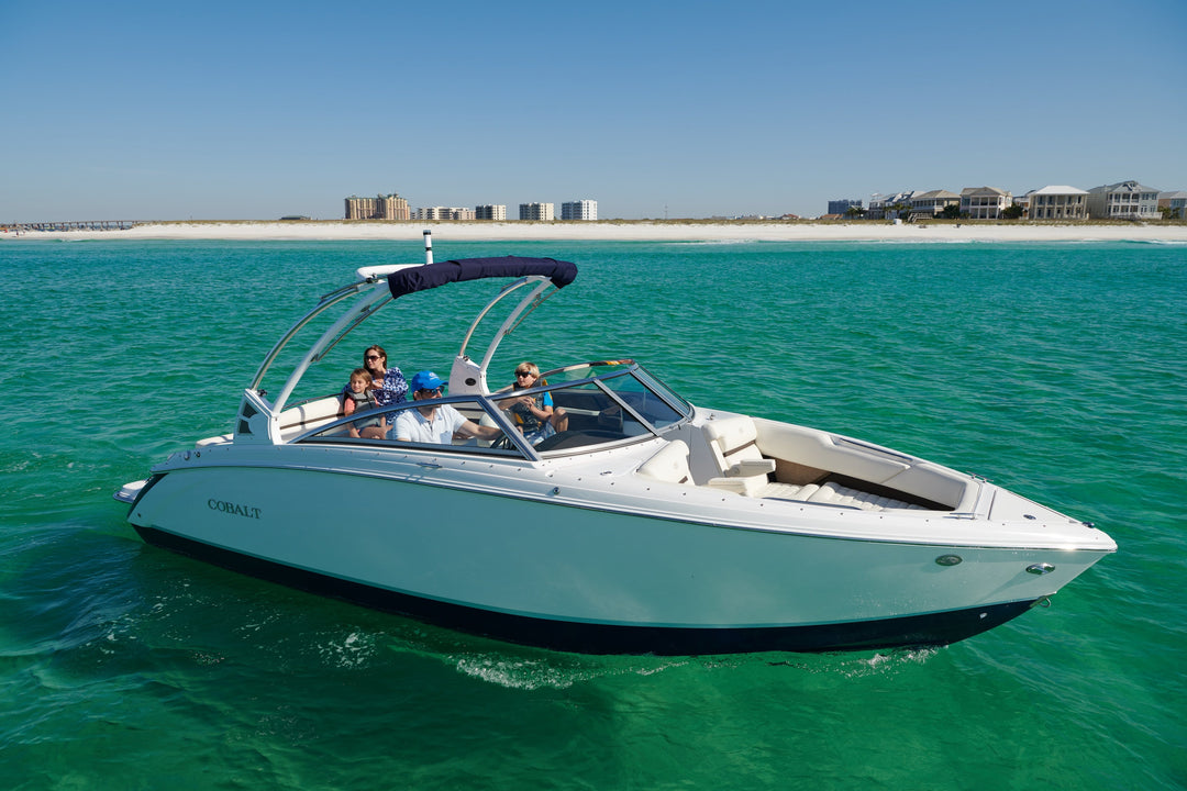 Cobalt Boats Eclipse Bimini on a boat with passengers enjoying a sunny day on clear turquoise waters.